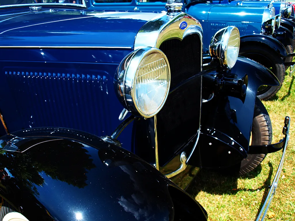 Blue cars lined up all in a row