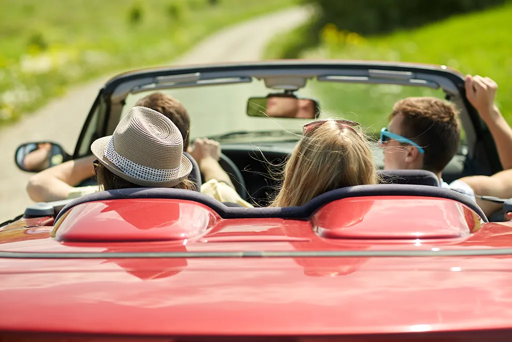 Group of teenagers in convertible